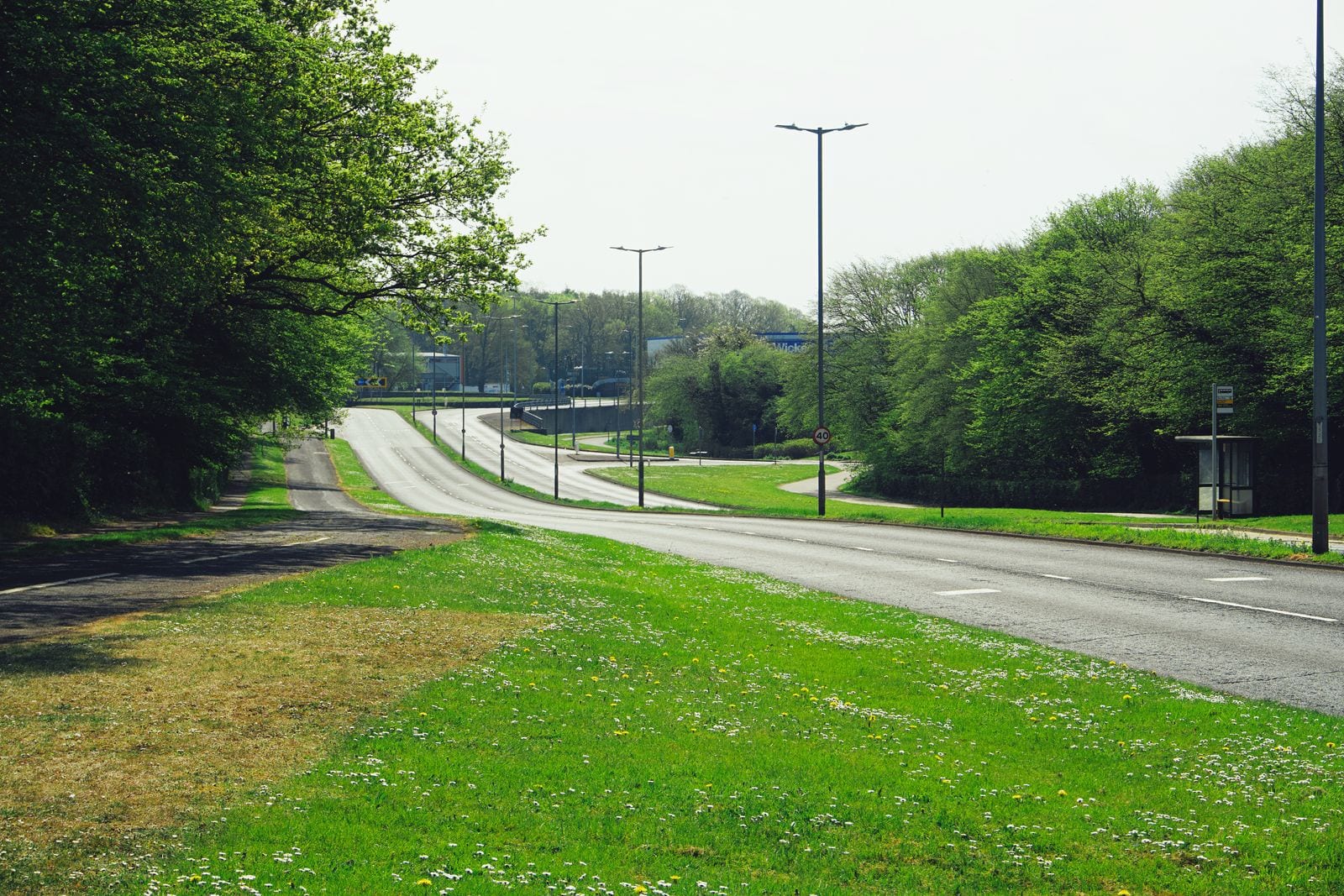 An English road with footways, kerbs, lighting and grass verges