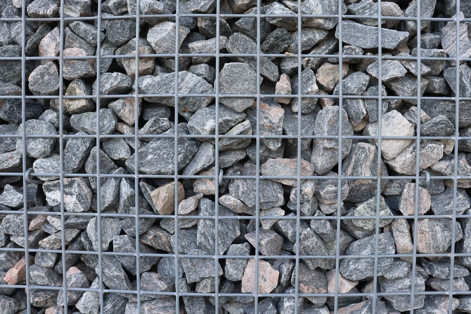 Natural stone packed into the steel mesh of a gabion wall
