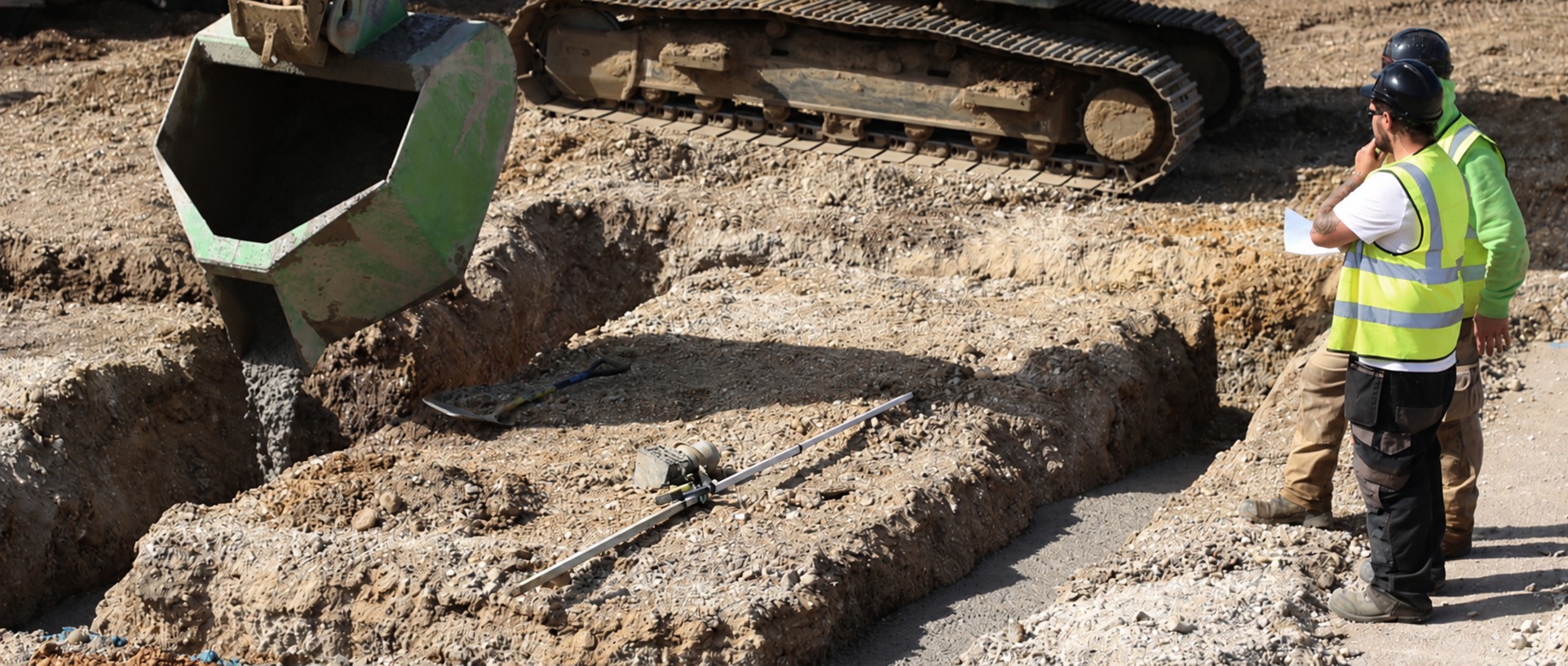 Concrete being placed into excavated strip foundations