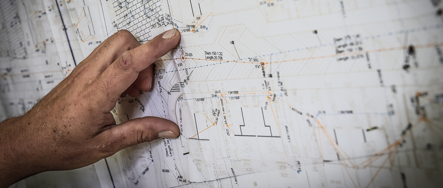 Reviewing levels and drainage details on a civil engineering drawing